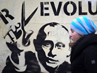 Девушка идет мимо стены с граффити с изображением Владимира Путина. Девушка идет мимо стены с граффити с изображением Владимира Путина.