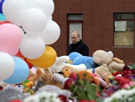 Президент РФ Владимир Путин возлагает цветы к стихийному мемориалу у торгового центра "Зимняя вишня" в Кемерово. 27 марта 2018
