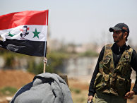 Солдат сирийской армии с флагом Сирии недалеко от Деръа Солдат сирийской армии с флагом Сирии недалеко от Деръа