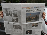 Мужчина читает газету The New York Times Мужчина читает газету The New York Times