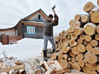 Мужчина рубит дрова в деревне Мужчина рубит дрова в деревне