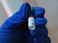 Медицинский работник держит в руке вакцину от COVID-19 "Спутник-V" Медицинский работник держит в руке вакцину от COVID-19 "Спутник-V"